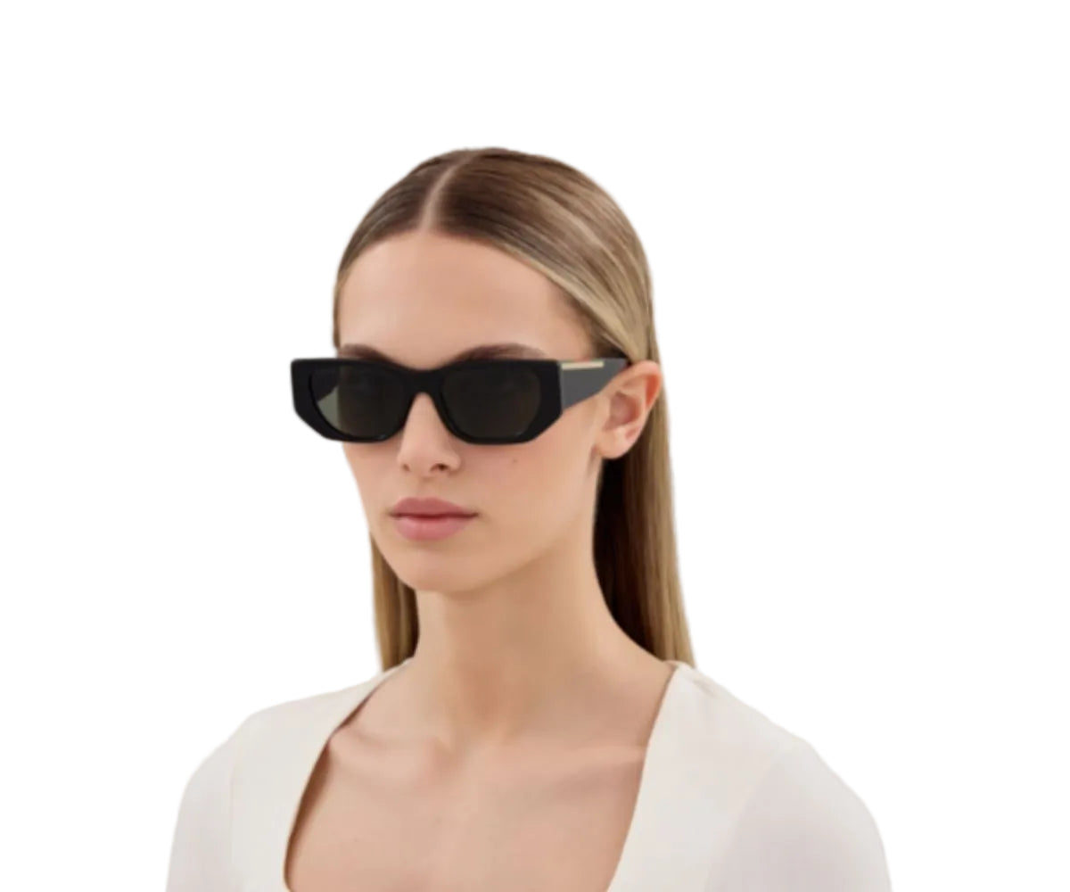 Black rectangular designer sunglasses with gold accent, worn by woman in white top