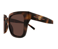 Tortoiseshell Gucci sunglasses with green-red-green stripe and gold logo on temple view 3