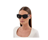 Black Gucci sunglasses with red and green web stripe on temples, worn by woman in white top view 4